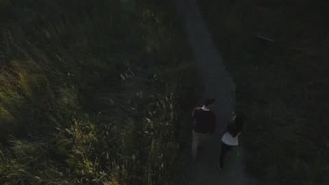 A Couple Walks Through A Park