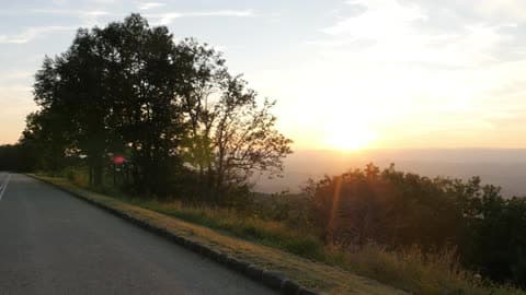 A First Person View Of Driving Down A Mountain Road