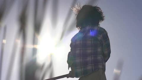 A Kid Swinging A Stick