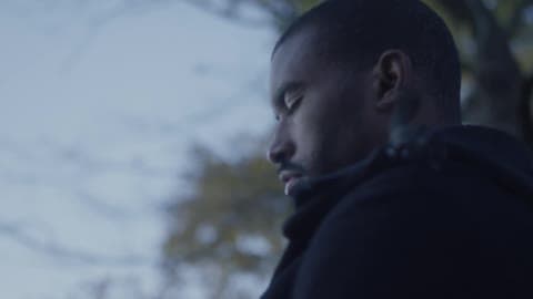 A Man Stands Outside With His Eyes Closed