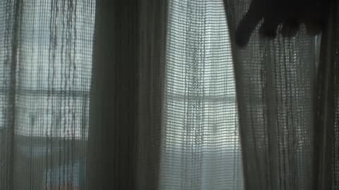 A Person Feeling Some Curtains
