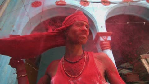 A Person Removing A Face Cover