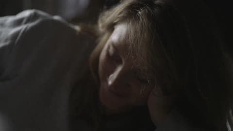 A Person Resting Their Head On Their Arm