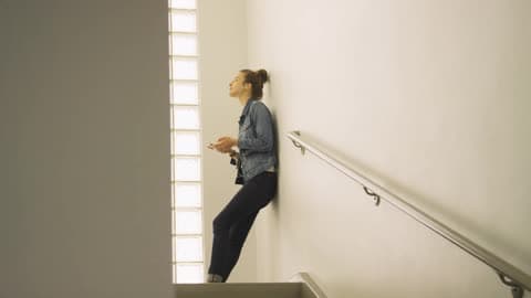 A Person Standing At The Top Of A Staircase
