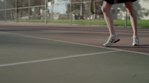 A Tennis Player Serves And Then Runs To The Net