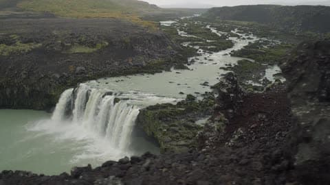 A Waterfall Cascades Over A Mountain