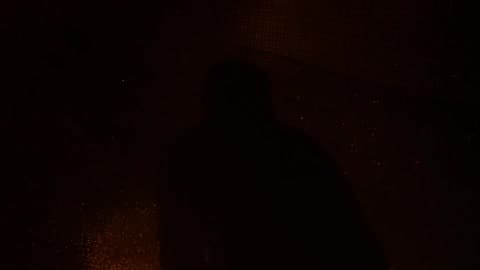 Firework Sparks Fly Around A Silhouetted Man