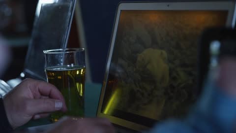 Glass Of Beer Next To A Screen