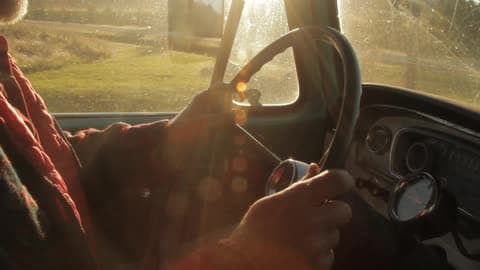 Man Driving His Vehicle And Turning Left At The Crossing