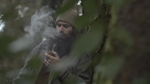 Man Smokes His Pipe In The Forest
