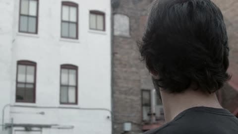Man Standing And Looking At Buildings