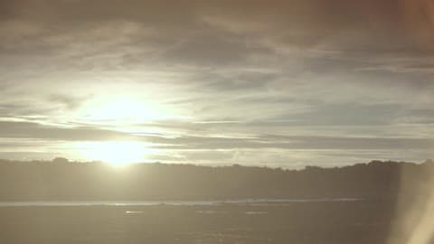 View Of A Cloudy Sky Over Hills At Sunrise